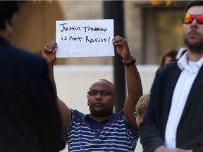 A man holds a sign as  Justin Trudeau speaks in Winnipeg last week. Many readers agree with him.