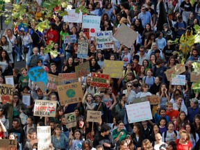 Students hold placards as they take part in the Fridays for Future climate change action protest in Paris, France, September 20, 2019.