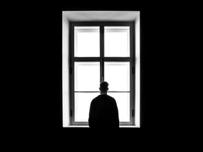 A man looks out of a window.