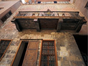 A man stands in the balcony of an Ottoman-era house in Darb al-Ahmar neighbourhood in Cairo, Egypt August 31, 2019.