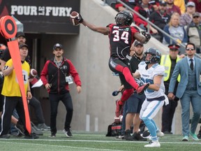 Ottawa Redblacks defensive back De'Chavon Hayes gets a hand on the ball in front of Toronto Argonauts wide receiver Jimmy Ralph in the first half at TD Place Stadium on Saturday, Sept. 7, 2019.