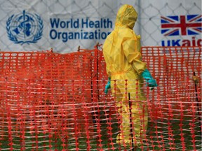A file photo shows an unidentified person dressed in Ebola protective apparel inside an Ebola care facility at the Bwera general hospital near the border with the Democratic Republic of Congo in Bwera, Uganda, in June.