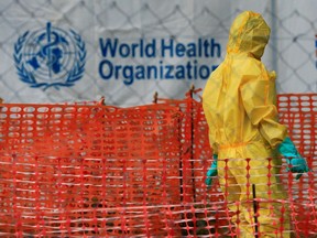FILE PHOTO: A person dressed in Ebola protective apparel is seen inside an Ebola care facility at the Bwera general hospital near the border with the Democratic Republic of Congo in Bwera, Uganda, June 14, 2019.