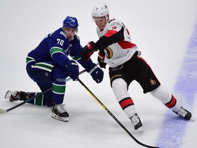 Vancouver Canucks forward Tanner Pearson battles for the puck against Ottawa Senators forward Brady Tkachuk during the second period at Rogers Arena on Wednesday, Sept. 26, 2019.