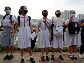 Anti-government protesters hold hands to prepare a human chain in Sha Tin at the banks of the Shing Mun River in Hong Kong, China September 19, 2019.