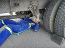Mechanic inspects a commercial vehicle at a police safety blitz. File
