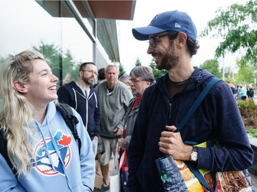 Jillian Brenner (L) and Travis Webb (L) lined up at 8:25am for the 10am start for a sell off of a record collection by the Friends of the Ottawa PublicLibrary, at the James Bartleman Archives.