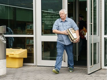 Richard Kowalski walks out with a large collection of classical records during a sell off of a record collection by the Friends of the Ottawa Public Library, at the James Bartleman Archives.