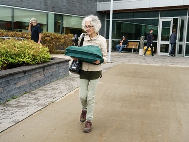 Esther Becker walks out with a bag of records during a sell off of a record collection by the Friends of the Ottawa Public Library, at the James Bartleman.