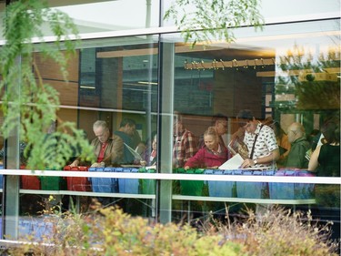 People sorting through thousands of records during a sell off of a record collection by the Friends of the Ottawa Public Library, at the James Bartleman Archives.