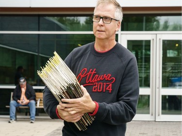 James Lariviere leaves with a handful of records during a sell off of a record collection by the Friends of the Ottawa Public Library, at the James Bartleman Archives.