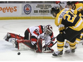 Kingston Frontenacs Adrien Beraldo knocks the puck loose from Ottawa 67's goalie Cedrick Andree during Ontario Hockey League action at the Leon's Centre in Kingston on Friday March 8, 2019.