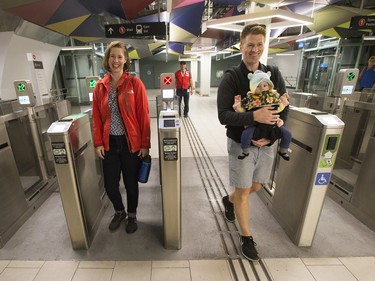 Andrew Maffrey and Daphne Lessard with their daughter Sabine come through the gates at Parliament Station as the LRT officially opens on September 14, 2019 complete with ceremonies at Tunney's Pasture.