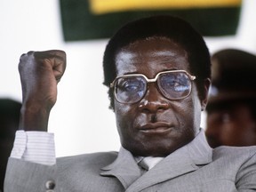 In this file photo taken on July 1, 1984, Zimbabwe's Prime Minister Robert Mugabe clenches his fist during a meeting in Harare stadium.