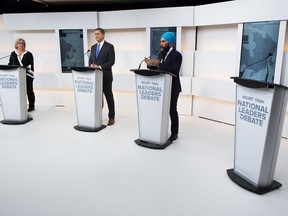 A empty podium stand where Liberal Leader Justin Trudeau turned down the invitation for the debate as Green Party Leader Elizabeth May, left, Conservative Leader Andrew Scheer, centre, and NDP Leader Jagmeet Singh take part during the Maclean's/Citytv National Leaders Debate in Toronto on Thursday, September 12, 2019.