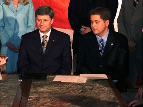 Stephen Harper, shown here in 2005 with fellow MP Andrew Scheer, made deep spending cuts once in power.