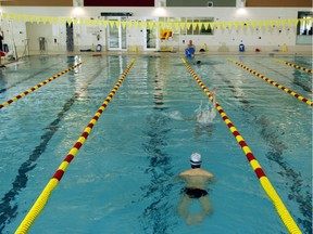 File: Swimmers do laps in a city pool.
