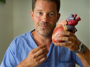 Dr. David Woods with stent and model of heart at Vancouver General Hospital. Photo: Arlen Redekop/Postmedia