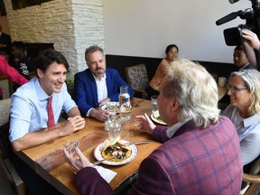 Liberal Leader Justin Trudeau speaks with people in a cafe as he mainstreets in downtown Winnipeg on Thursday, Sept.19, 2019.