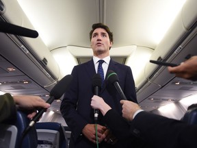 Liberal Leader Justin Trudeau makes a statement in regards to photo coming to light of himself from 2001 wearing "brownface" during a scrum on his campaign plane in Halifax, N.S., on Wednesday, September 18, 2019.
