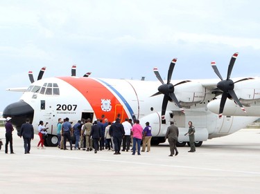 Prime Minister Hubert MInnis boards a U.S. Coast Guard plane, en route to Abaco for a reconnaissance flight to survey damage caused by Hurricane Dorian, in Nassau, Bahamas on Tuesday.