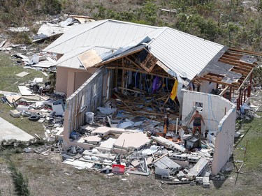 Residents look through debris after hurricane Dorian hit the Grand Bahama Island in the Bahamas,September 4, 2019.