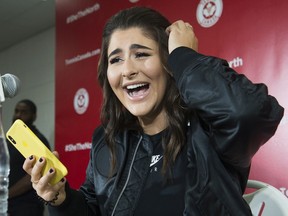 Bianca Andreescu laughs after reading a message from rapper Drake as she speaks to the media after she became the first Canadian player to win a Grand Slam singles title when she defeated Serena Williams in the final of the US Open, in Toronto on Wednesday, September 11, 2019.