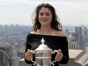 U.S. Open winner Bianca Andreescu poses with her trophy at top of the Rock in New York, U.S., September 8, 2019, in this screen grab obtained from a video.