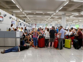 Passengers are seen at Thomas Cook check-in points at Mallorca Airport after the world's oldest travel firm collapsed stranding hundreds of thousands of holidaymakers around the globe and sparking the largest peacetime repatriation effort in British history, in Palma de Mallorca, Spain, September 23, 2019.