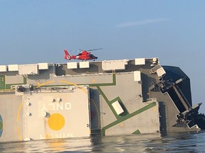 A U.S. Coast Guard rescue helicopter sits on an overturned cargo ship on September 9, 2019 near Brunswick, off St. Simons Island in Georgia.