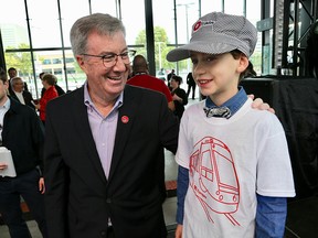 Jim Watson meets Tay Reeves,8, who wore a conductors cap to the ceremonies this am at Tunney's Pasture LRT Station.