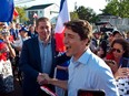 Prime Minister Justin Trudeau shakes hands with Conservative Leader Andrew Scheer while walking with the crowd in Dieppe, N.B., Thursday, Aug. 15, 2019.