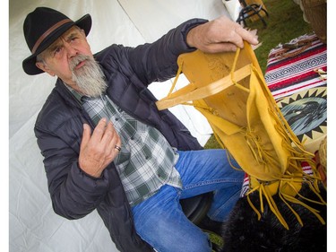 Anishinabe Nibin, or "Algonquin summer," was celebrated in Gatineau Park on Saturday, Oct. 12, 2019, where people could learn more about the traditional Algonquin way of life, as well as a chance to see artisans at work. Pinock, an exhibitor, shows various items off.   Ashley Fraser/Postmedia