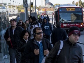 OC Transpo buses arrive at Tunney's Pasture LRT station with passengers.