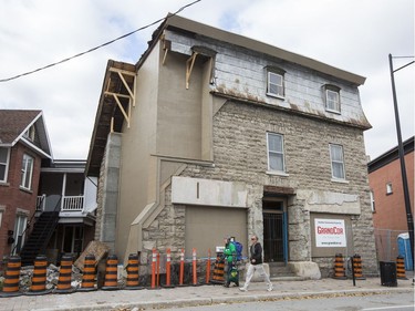 Workers have removed the sidewalk barricade in front of Magee House on Wellington St. after engineers deemed the building safe following repairs to the structure of the heritage building.