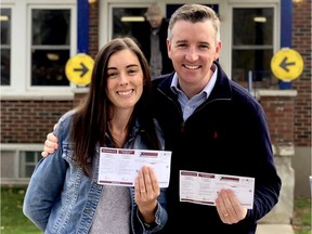 Michael Barrett and his wife, Amanda, pose with voter cards outside their polling station at the Spencerville Legion on Monday in a photo on Twitter.