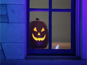 A jack-o-lantern sits in a window of a building at Ottawa City Hall. October 26, 2019.