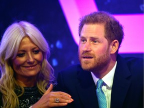 Prince Harry, Duke of Sussex reacts next to television presenter Gaby Roslin as he delivers a speech during the WellChild awards at Royal Lancaster Hotel on Tuesday in London, England.