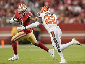 Raheem Mostert #31 of the San Francisco 49ers fights off the tackle of Eric Murray #22 of the Cleveland Browns during the fourth quarter of an NFL football game at Levi's Stadium on October 07, 2019.