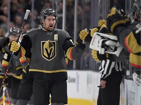 Mark Stone of the Vegas Golden Knights celebrates with teammates on the bench after scoring a first-period power-play goal against the Boston Bruins during their game at T-Mobile Arena on October 8, 2019 in Las Vegas, Nevada.