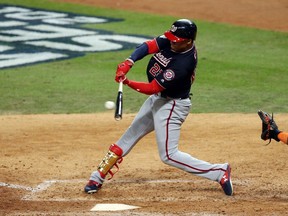 HOUSTON, TEXAS - OCTOBER 22:  Juan Soto #22 of the Washington Nationals singles against the Houston Astros during the eighth inning in Game One of the 2019 World Series at Minute Maid Park on October 22, 2019 in Houston, Texas.