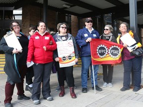 A few members of the public service stand in front of the Terrasses de la Chaudière, where workers are are having issues with bats and air quality.