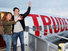 Liberal leader and Prime Minister Justin Trudeau waves with his wife Sophie Gregoire Trudeau as they board the plane at the airport in Vancouver, Oct. 12, 2019. REUTERS/Stephane Mahe