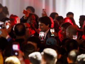 Liberal Leader and Canadian Prime Minister Justin Trudeau walks through supporters as he leaves the stage alongside his wife Sophie Grégoire Trudeau after delivering his victory speech at his election night headquarters on October 21, 2019 in Montreal, Canada.