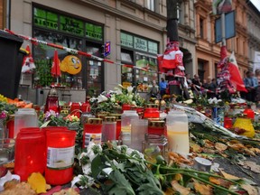 This picture taken in front of the 'Kiez Doener' restaurant on October 13, 2019 in Halle, Eastern Germany, shows a makeshift memorial of candles and flowers for the victims of a deadly shooting during an attack targeting the Turkish restaurant after an attempt at a synagogue. - The German suspect in the attack targeting the synagogue has admitted to the shooting rampage and confessed that it was motivated by anti-Semitism and right-wing extremism, federal prosecutors said