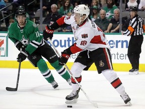 Ryan Dzingel of the Ottawa Senators skates the puck against Curtis McKenzie of the Dallas Stars, March 8, 2017 in Dallas, Texas.