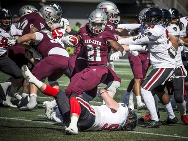 Gee-Gee's #21 Jordan Burgher keeps the ball away from the Ravens.