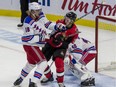 Ottawa Senators Drake Batherson battles with New York Rangers Marc Staal in front of goaltender Alexandar Georgiev during NHL hockey action at the Canadian Tire Centre in Ottawa on October 5, 2019.