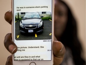 Keri Pilgrim shows a cell phone picture of her shared car parked at her residence that was towed and cost $800 to get back. October 4, 2019.