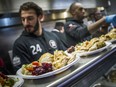 The Salvation Army Ottawa Booth Centre hosted its annual Thanksgiving Dinner on Sunday. Redblacks players (left to right) Anthony Cioffi and R.J. Harris were on hand to help out serving up the special meal.